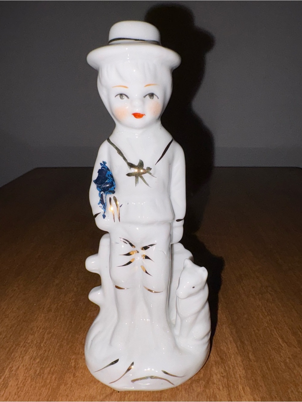 Vintage White Porcelain Dutch Boy and Dog Figurine with Gold and Blue Accents